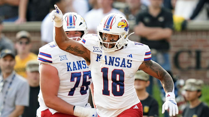 Sep 6, 2025; Columbia, Missouri, USA; Kansas Jayhawks tight end DeShawn Hanika (18) celebrates with offensive lineman Antonio Wilson (76) after scoring a touchdown during the second half against the Missouri Tigers at Faurot Field at Memorial Stadium. Mandatory Credit: Jay Biggerstaff-Imagn Images