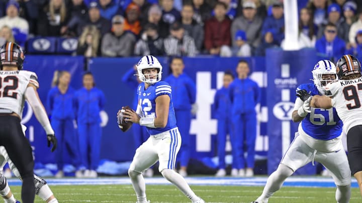Oct 18, 2024; Provo, Utah, USA; Brigham Young Cougars quarterback Jake Retzlaff (12) drops back to pass against the Oklahoma State Cowboys during the first quarter at LaVell Edwards Stadium. Mandatory Credit: Rob Gray-Imagn Images