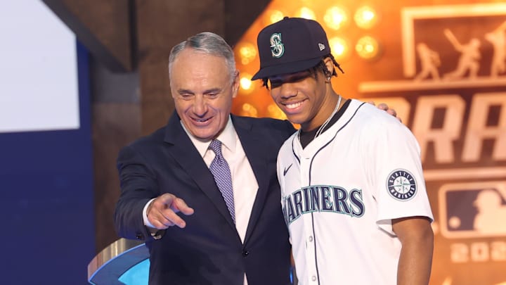 MLB Commissioner Rob Manfred takes a photo with Jurrangelo Cijntje after being drafted by the Seattle Mariners with the 15th pick during the first round of the MLB Draft at Cowtown Coliseum in 2024. MLB Commissioner Rob Manfred takes a photo with Jurrangelo Cijntje after being drafted by the Seattle Mariners with the 15th pick during the first round of the MLB Draft at Cowtown Coliseum in 2024.