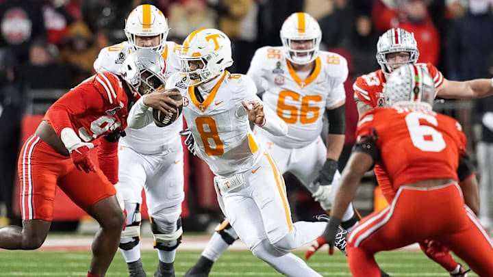 Tennessee quarterback Nico Iamaleava (8) scrambles between Ohio State defenders during a College Football Playoff first round game between Tennessee and Ohio State held at Ohio Stadium in Columbus, Ohio, on Saturday, Dec. 21, 2024.