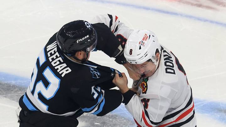 Oct 1, 2026; Salt Lake City, Utah, USA;  Utah Mammoth defenseman MacKenzie Weegar (52) and Chicago Blackhawks center Ryan Donato (8) fight during the third period at Delta Center.  Mandatory Credit: Rob Gray-Imagn Images