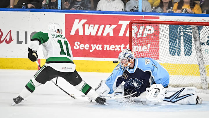 Milwaukee Admirals goaltender Troy Grosenick (1) turns away a shot by Texas Stars forward Logan