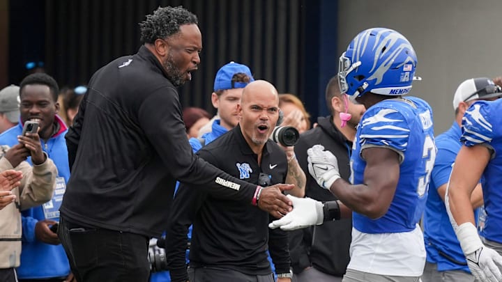 Tim Duncan, Memphis senior deputy athletics director, and Ed Scott, athletic director, celebrate with Memphis' Elijah Herring (31) after the defense sacked Charlotte's Deshawn Purdie (15) for a safety during the game between Charlotte and the University of Memphis at Simmons Bank Liberty Stadium on Saturday, October 26, 2024.