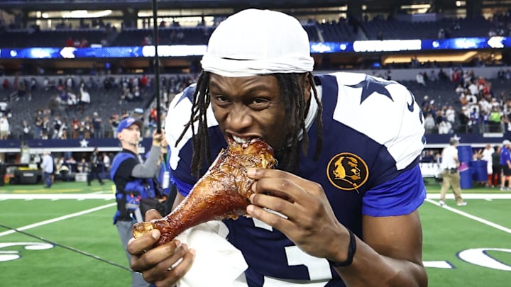Dallas Cowboys wide receiver George Pickens celebrates by eating turkey after the game against the Kansas City Chiefs 