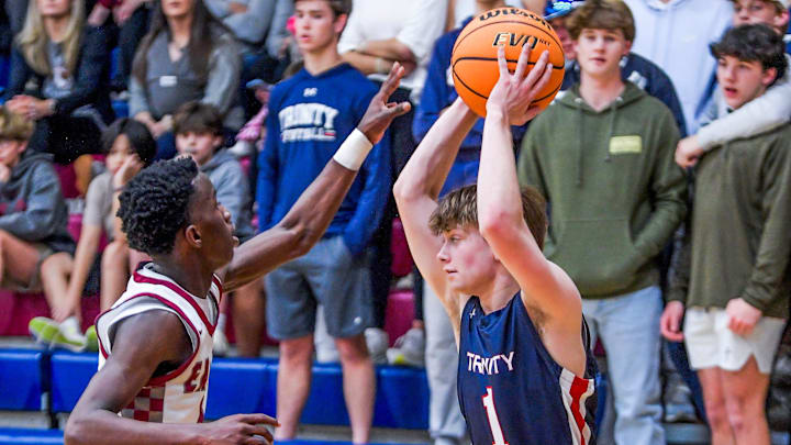 Trinity's Mac Stewart (1) is defended by Alabama Christian's Tyree Saadiq (2) in AHSAA Area Tournament action at the Montgomery Academy campus in Montgomery, Ala., on Monday February 5, 2024.