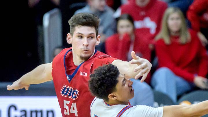 UIC's Cameron Fens (54) tries to stop Bradley's Christian Davis in the second half of their Missouri Valley Conference basketball game Wednesday, Feb. 14, 2024 at Carver Arena in Peoria. The Braves defeated the Flames 85-73.