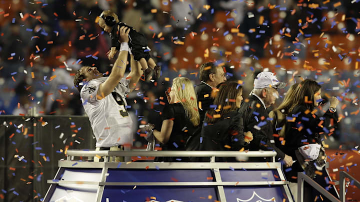 Feb 7, 2010; Miami, FL, USA; New Orleans Saints quarterback Drew Brees (9) celebrates with his son Braylen Brees after defeating the Indianapolis Colts 31-17 in Super Bowl XLIV at Sun Life Stadium. Mandatory Credit: Jeff Hanisch-Imagn Images