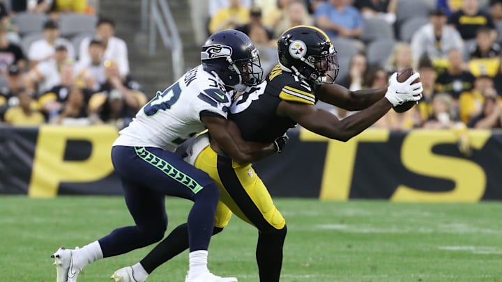 Aug 13, 2022; Pittsburgh, Pennsylvania, USA;  Pittsburgh Steelers wide receiver Miles Boykin (13) pulls in a pass as Seattle Seahawks cornerback Mike Jackson (30) defends during the second quarter at Acrisure Stadium. Mandatory Credit: Charles LeClaire-Imagn Images