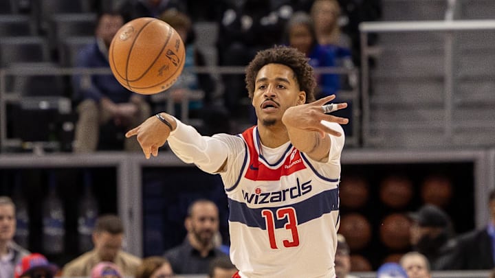 Mar 11, 2025; Detroit, Michigan, USA; Washington Wizards guard Jordan Poole (13) passes the ball against the Detroit Pistons during the first half at Little Caesars Arena. Mandatory Credit: David Reginek-Imagn Images