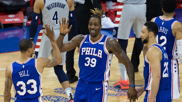 Jun 2, 2021; Philadelphia, Pennsylvania, USA; Philadelphia 76ers center Dwight Howard (39) celebrates with guards George Hill (33) and Ben Simmons (25) during the third quarter against the Washington Wizards in game five of the first round of the 2021 NBA Playoffs at Wells Fargo Center. Mandatory Credit: Bill Streicher-Imagn Images