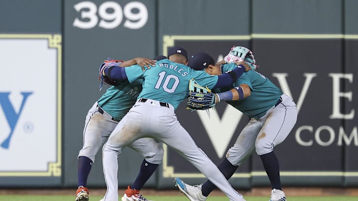 Seattle Mariners center fielder Julio Rodriguez (44) celebrates with left fielder Randy Arozarena (56) and right fielder Victor Robles (10) after the game against the Houston Astros at Minute Maid Park in 2024.