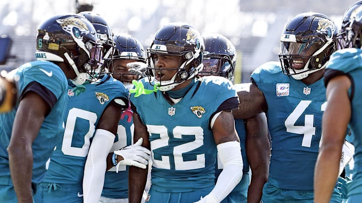 Oct 27, 2024; Jacksonville, Florida, USA; Jacksonville Jaguars defensive back Jarrian Jones (22) celebrates after an interception with defensive end Josh Hines-Allen (41) and safety Daniel Thomas (20) during the first half against the Green Bay Packers at EverBank Stadium. Mandatory Credit: Melina Myers-Imagn Images