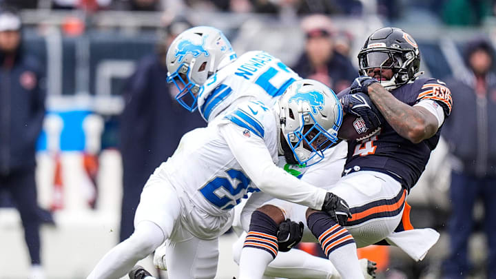 Detroit Lions cornerback Amik Robertson (21) tackles Chicago Bears running back D'Andre Swift (4) during the first half at Soldier Field in Chicago, Ill. on Sunday, Dec. 22, 2024.