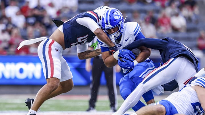 Oct 11, 2025; Tucson, Arizona, USA; Brigham Young Cougars running back LJ Martin (4) gets tackled by Arizona Wildcats defensive back Dalton Johnson (43) during the first quarter of the game at Arizona Stadium. Mandatory Credit: Aryanna Frank-Imagn Images