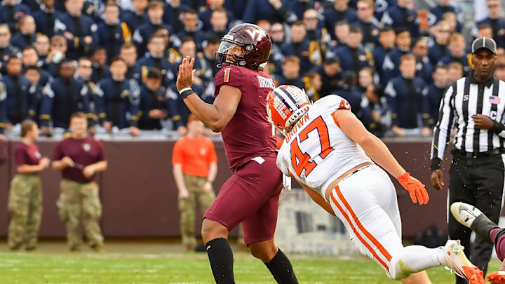 Nov 9, 2024; Blacksburg, Virginia, USA; Virginia Tech Hokies quarterback Kyron Drones (1) throws a pass while being pressured by Clemson Tigers linebacker Sammy Brown (47) during the second quarter at Lane Stadium. Mandatory Credit: Brian Bishop-Imagn Images Nov 9, 2024; Blacksburg, Virginia, USA; Virginia Tech Hokies quarterback Kyron Drones (1) throws a pass while being pressured by Clemson Tigers linebacker Sammy Brown (47) during the second quarter at Lane Stadium. Mandatory Credit: Brian Bishop-Imagn Images