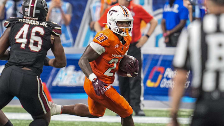 Aug 31, 2025; Atlanta, Ga.; Virginia Tech running back Marcellous Hawkins (27) runs against South Carolina.