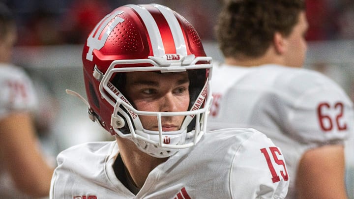 Indiana's Fernando Mendoza (15) gets loose before the Indiana versus Ohio State Big Ten Championship football game at Lucas Oil Stadium on Saturday, Dec. 6, 2025.