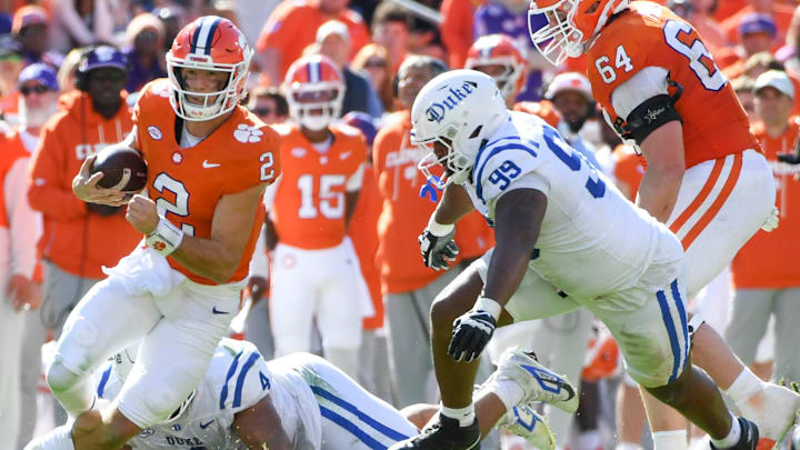 Clemson Tigers quarterback Cade Klubnik (2) rushes the ball while breaking the tackle of Duke Blue Devils defensive tackle Josiah Green (4) Saturday, Nov. 1, 2025, during the NCAA football game at Memorial Stadium in Clemson, South Carolina.