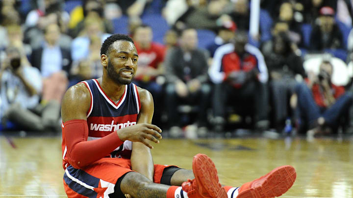 Dec 6, 2015; Washington, DC, USA; Washington Wizards guard John Wall (2) grimaces after suffering an apparent leg injury  during the second half at Verizon Center. Dallas Mavericks won 116 - 104. Mandatory Credit: Brad Mills-Imagn Images