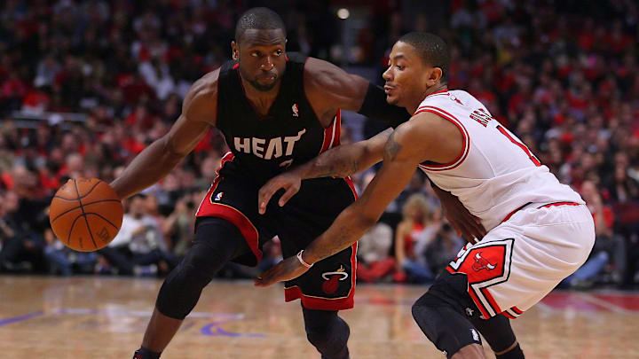 May 15, 2011; Chicago, IL, USA; Miami Heat shooting guard Dwyane Wade (3) controls the ball as he is defended by Chicago Bulls point guard Derrick Rose (1) in the second half of game one of the eastern conference finals of the 2011 NBA playoffs at the United Center. The Bulls defeated the Heat, 103-82. Mandatory Credit: Dennis Wierzbicki-Imagn Images