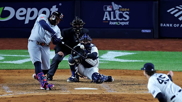 Oct 15, 2024; Bronx, New York, USA; Cleveland Guardians first base Josh Naylor (22) hits a RBI sacrifice fly during the fifth inning against the New York Yankees in game two of the ALCS for the 2024 MLB Playoffs at Yankee Stadium. Mandatory Credit: Brad Penner-Imagn Images