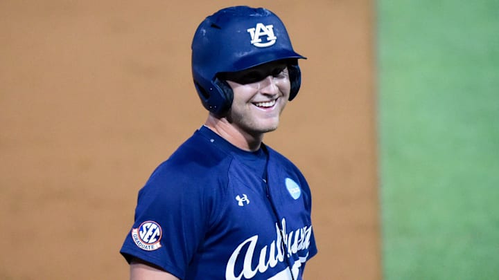 Auburn Tigers' Ike Irish (18) jokes with the dugout
