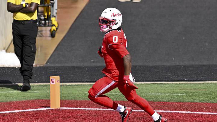 Oct 18, 2025; Houston, Texas, USA; Houston Cougars wide receiver Amare Thomas (0) runs the ball for a touchdown during the first quarter against the Arizona Wildcats at TDECU Stadium. Mandatory Credit: Maria Lysaker-Imagn Images 