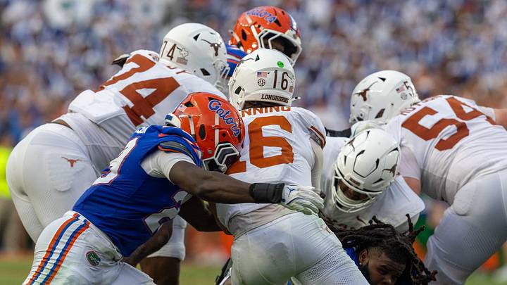 Texas quarterback Arch Manning (16) gets grabbed by Florida defensive back Josiah Davis (23) during the second half an NCAA football game in Gainesville, FL on Saturday, October 4, 2025. [Alan Youngblood/Gainesville Sun]