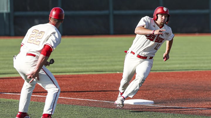 Indiana's Hogan Denny rounds third base as head coach Jeff Mercer keeps an eye on the relay throws during the Hoosiers' 8-0 win over Purdue on May 9, 2025. Indiana's Hogan Denny rounds third base as head coach Jeff Mercer keeps an eye on the relay throws during the Hoosiers' 8-0 win over Purdue on May 9, 2025.