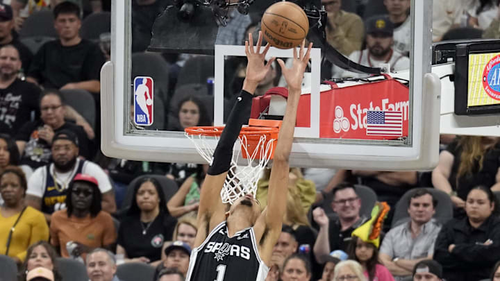 Apr 12, 2024; San Antonio, Texas, USA; San Antonio Spurs forward Victor Wembanyama (1) reaches above the rim for a pass during the second half against the Denver Nuggets at Frost Bank Center. Mandatory Credit: Scott Wachter-USA TODAY Sports