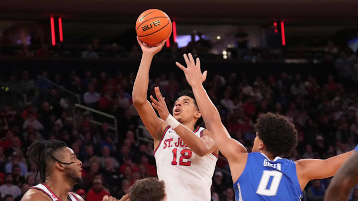 Mar 15, 2025; New York, NY, USA;  St. John's basketball guard RJ Luis Jr. (12) shoots against the Creighton Bluejays in the first half at Madison Square Garden.