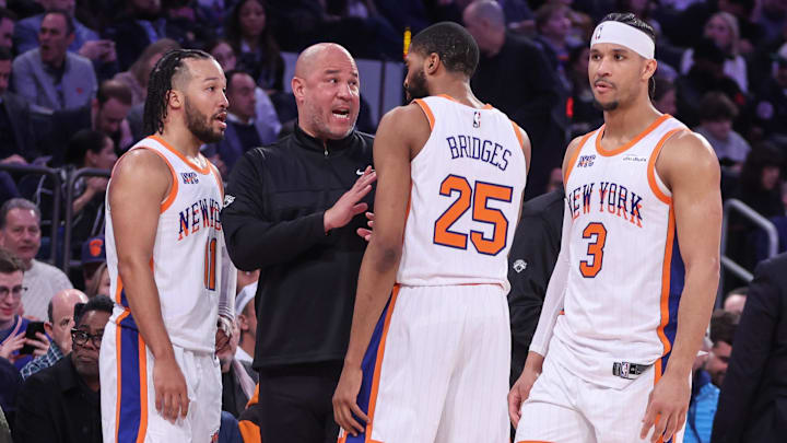 Feb 8, 2025; New York, New York, USA;  New York Knicks assistant coach Rick Brunson talks with New York Knicks guard Jalen Brunson (11), forward Mikal Bridges (25), and guard Josh Hart (3) during a timeout in the third quarter against the Boston Celtics at Madison Square Garden. Mandatory Credit: Wendell Cruz-Imagn Images