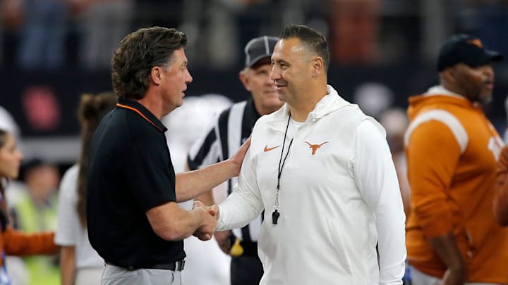 Texas head football coach Steve Sarkisian greets Oklahoma State head football coach Mike Gundy before the Big 12 Football Championship game between the Oklahoma State University Cowboys and the Texas Longhorns at the AT&T Stadium in Arlington, Texas, Saturday, Dec. 2, 2023.