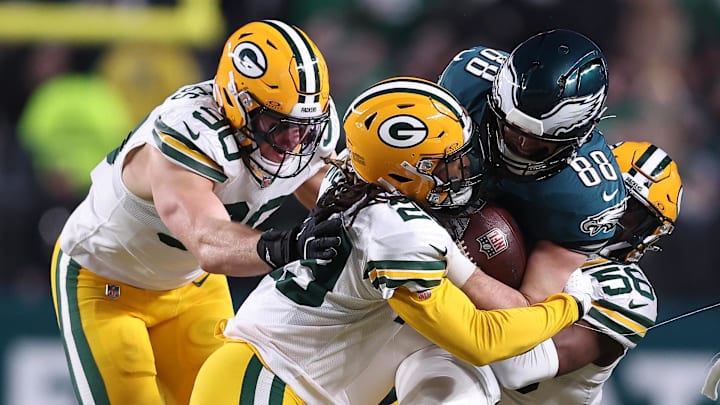 Philadelphia Eagles tight end Dallas Goedert (88) is tackled by Green Bay Packers safety Xavier McKinney and others.