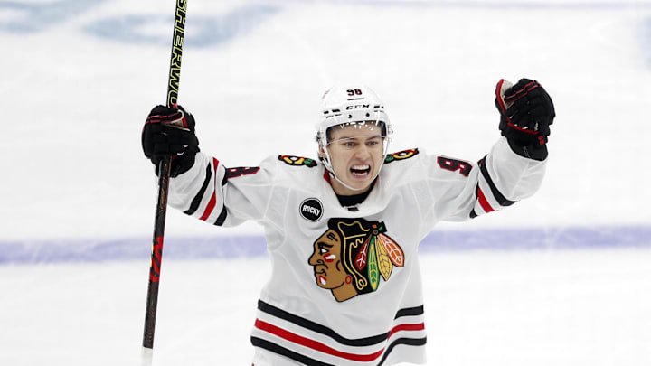 Oct 10, 2023; Pittsburgh, Pennsylvania, USA; Chicago Blackhawks center Connor Bedard (98) reacts to a goal by center Ryan Donato (not pictured) against the Pittsburgh Penguins during the second period at the PPG Paints Arena. Beard assisted on the goal to record his first NHL point in his league debut. Mandatory Credit: Charles LeClaire-Imagn Images