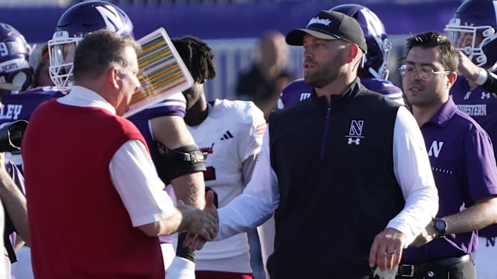 Aug 31, 2024; Evanston, Illinois, USA; Miami (Oh) Redhawks head coach Chuck Martin and Northwestern Wildcats head coach David Braun shake hands after the game at Lanny and Sharon Martin Stadium. Mandatory Credit: David Banks-Imagn Images