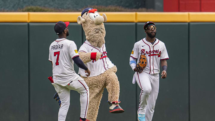 Aug 9, 2025; Cumberland, Georgia, USA; Atlanta Braves left fielder Jurickson Profar (7) team mascot Blooper and center fielder Michael Harris II react after the Braves defeated the Miami Marlins at Truist Park. Mandatory Credit: Dale Zanine-Imagn Images