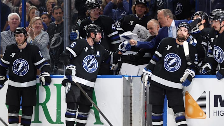Oct 25, 2025; Tampa, Florida, USA; Tampa Bay Lightning right wing Nikita Kucherov (86) is congratulated by head coach Jon Cooper after he got an assist and his 1,000 career point against the Anaheim Ducks during the second period at Benchmark International Arena. Mandatory Credit: Kim Klement Neitzel-Imagn Images