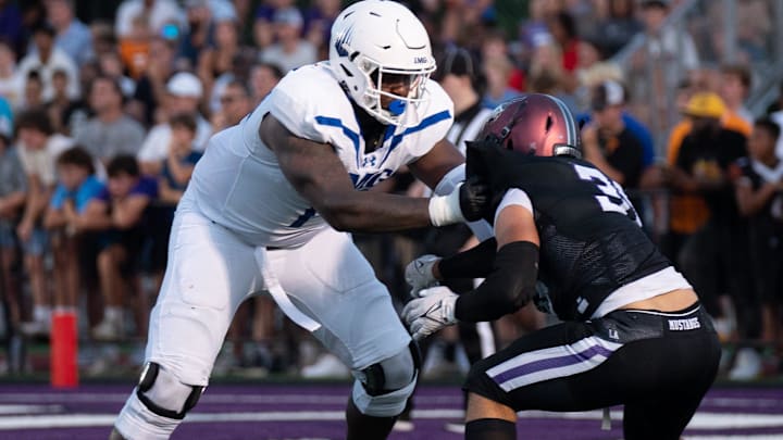 IMG's Jordan Seaton (77) holds off Lipscomb's Beck Woodside (35) at Lipscomb's Reese Smith Football