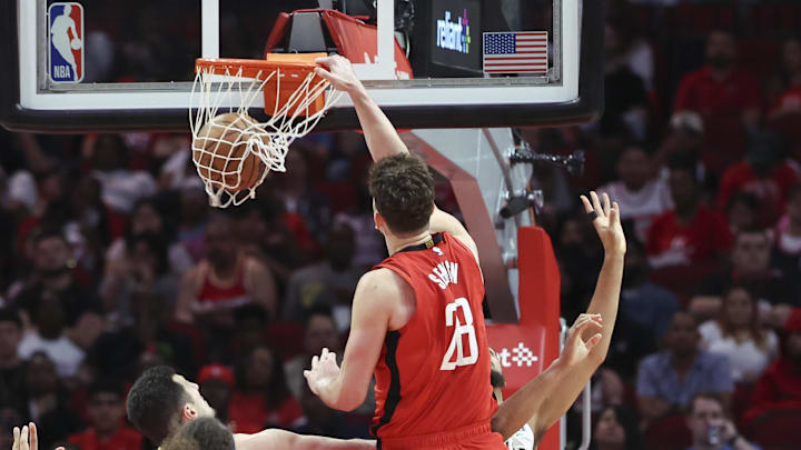 Mar 8, 2025; Houston, Texas, USA;  Houston Rockets center Alperen Sengun (28) dunks the ball as New Orleans Pelicans forward Jeremiah Robinson-Earl (50) defends during the first quarter at Toyota Center. Mandatory Credit: Troy Taormina-Imagn Images