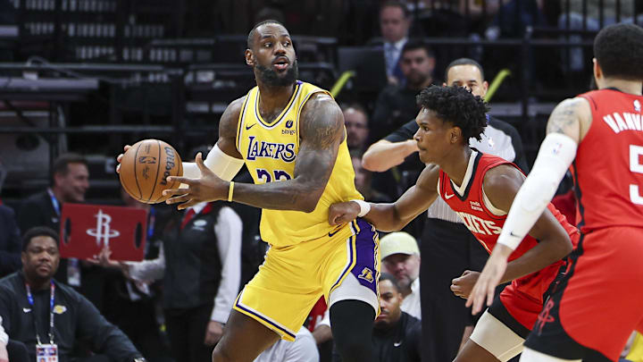 Jan 29, 2024; Houston, Texas, USA; Los Angeles Lakers forward LeBron James (23) controls the ball as Houston Rockets forward Amen Thompson (1) defends during the second quarter at Toyota Center. Mandatory Credit: Troy Taormina-Imagn Images