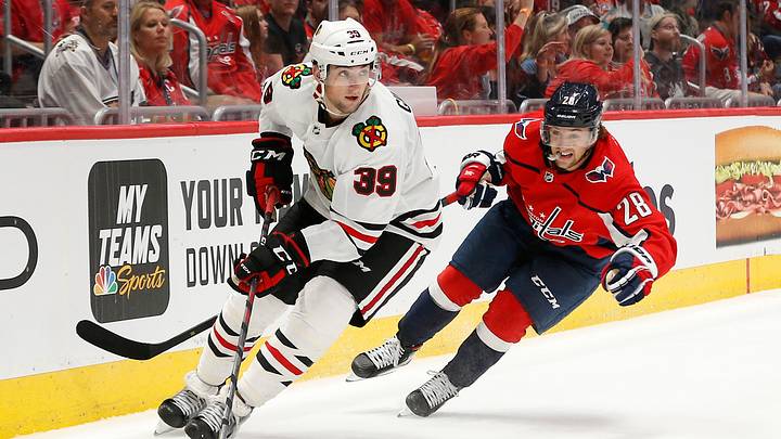 Sep 16, 2019; Washington, DC, USA; Chicago Blackhawks defenseman Dennis Gilbert (39) skates with the puck as Washington Capitals left wing Brendan Leipsic (28) chases in the third period at Capital One Arena. Mandatory Credit: Geoff Burke-USA TODAY Sports