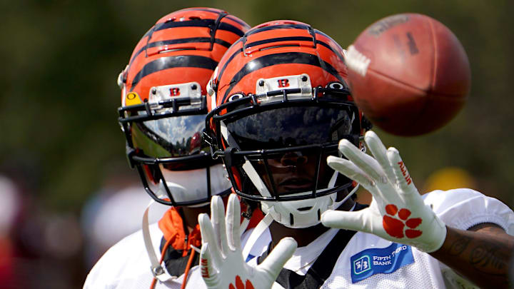 Cincinnati Bengals wide receiver Tee Higgins (85) catches passes from Jugs football passing machine as wide receiver Ja'Marr Chase (1), background, assists at the conclusion of Cincinnati Bengals training camp practice, Friday, July 29, 2022, at the practice fields next to Paul Brown Stadium in Cincinnati.
Cincinnati Bengals Training Camp July 29 0033 Cincinnati Bengals wide receiver Tee Higgins (85) catches passes from Jugs football passing machine as wide receiver Ja'Marr Chase (1), background, assists at the conclusion of Cincinnati Bengals training camp practice, Friday, July 29, 2022, at the practice fields next to Paul Brown Stadium in Cincinnati.
Cincinnati Bengals Training Camp July 29 0033