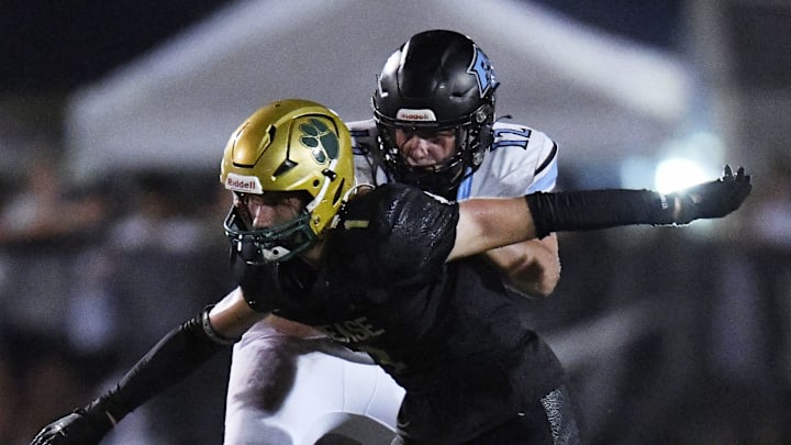 Ponte Vedra Sharks Caleb Stanton (12) tries to control Nease Panthers Jacob Curry (1) during late third quarter action. The Nease Panthers hosted the Ponte Vedra Sharks in High School Football Friday evening, August 23, 2024. The Panthers were the 24 to 7 victors over the Sharks. Ponte Vedra Sharks Caleb Stanton (12) tries to control Nease Panthers Jacob Curry (1) during late third quarter action. The Nease Panthers hosted the Ponte Vedra Sharks in High School Football Friday evening, August 23, 2024. The Panthers were the 24 to 7 victors over the Sharks.