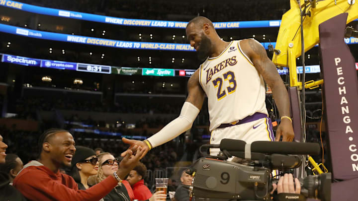 Nov 19, 2023; Los Angeles, California, USA;  Los Angeles Lakers forward LeBron James (23) shakes hands with his son Bronny James during the second half against the Houston Rockets at Crypto.com Arena. Mandatory Credit: Kiyoshi Mio-Imagn Images