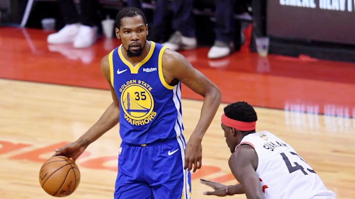 Golden State Warriors forward Kevin Durant dribbles in front of  Toronto Raptors forward Pascal Siakam.