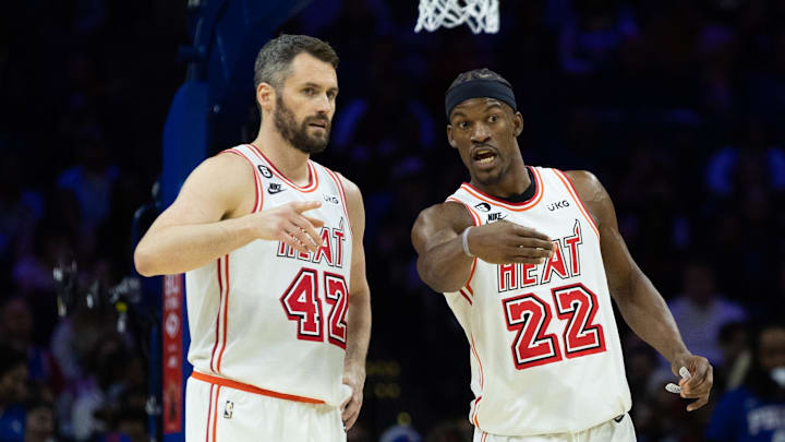 Feb 27, 2023; Philadelphia, Pennsylvania, USA; Miami Heat forward Jimmy Butler (22) talks with forward Kevin Love (42) during a break in action in the second quarter against the Philadelphia 76ers at Wells Fargo Center. Mandatory Credit: Bill Streicher-Imagn Images