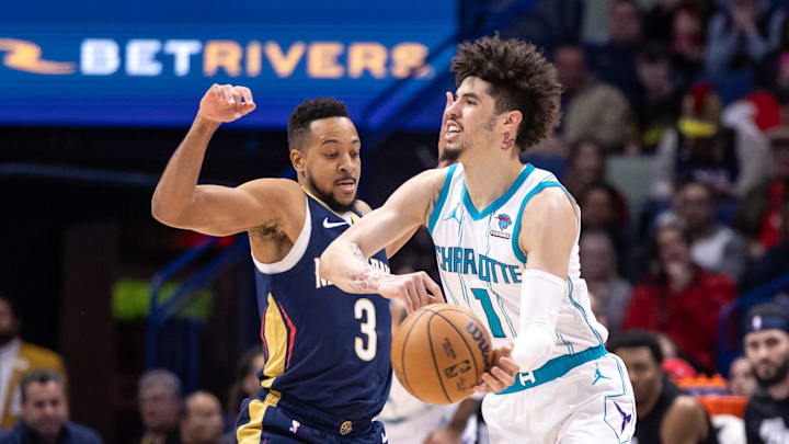 Jan 17, 2024; New Orleans, Louisiana, USA; Charlotte Hornets guard LaMelo Ball (1) looks to pass the ball against New Orleans Pelicans guard CJ McCollum (3) during the first half at Smoothie King Center. Mandatory Credit: Stephen Lew-Imagn Images