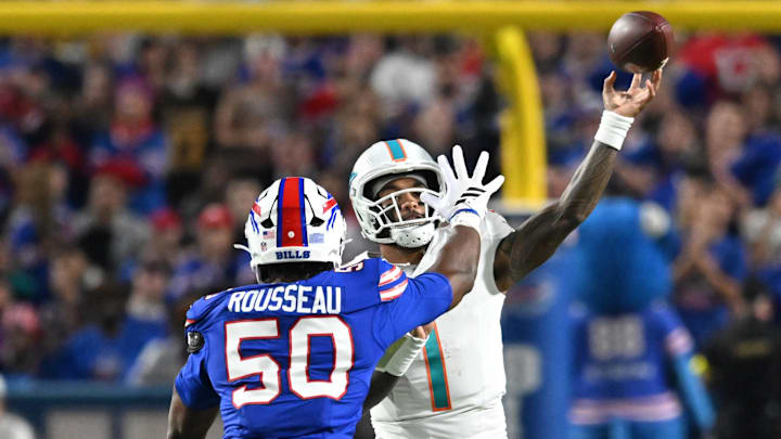 Sep 18, 2025; Orchard Park, New York, USA; Miami Dolphins quarterback Tua Tagovailoa (1) passes against Buffalo Bills defensive end Greg Rousseau (50) in the second quarter