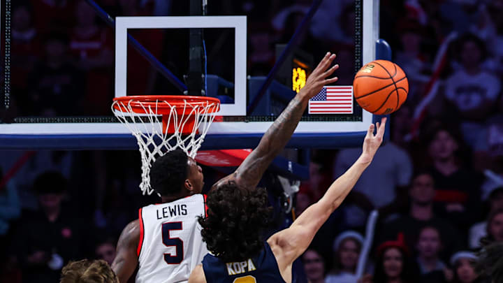 Nov 4, 2024; Tucson, Arizona, USA; Arizona Wildcats guard KJ Lewis (5) blocks Canisius Golden Griffins guard Tana Kopa (6) from a lay up during the second half at McKale Center. Mandatory Credit: Aryanna Frank-Imagn Images